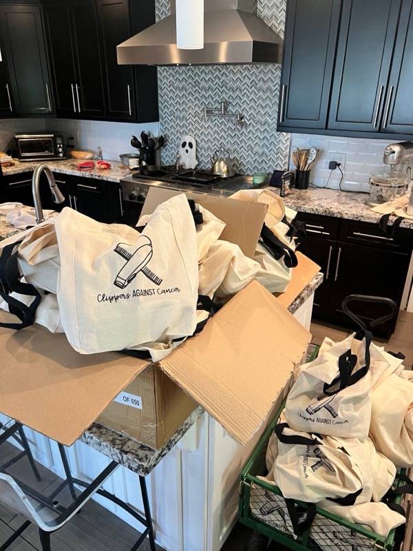 Clippers Against Cancer tote bags being packed for delivery