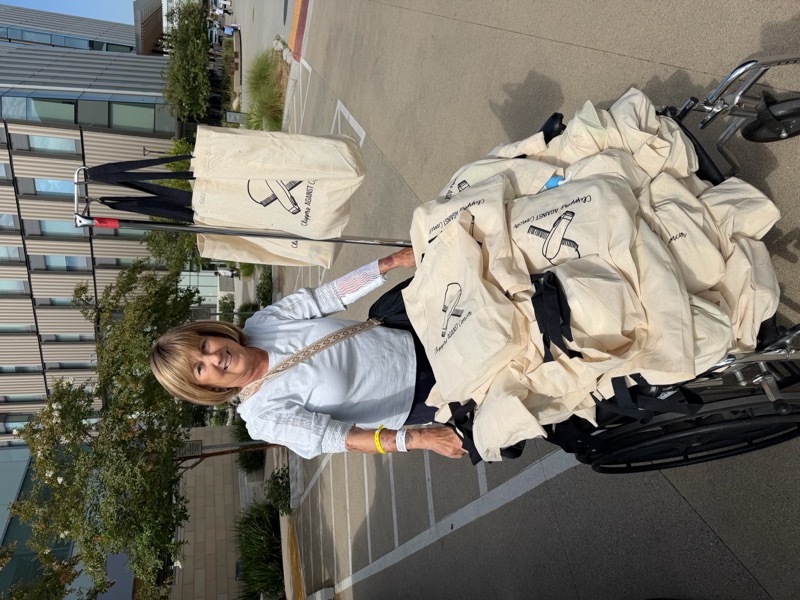 Delivering a wheelchair full of Chemo Care Baskets to a hospital